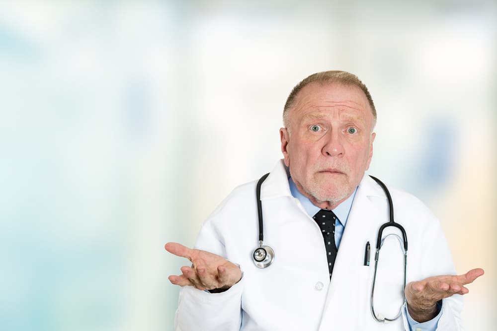 Closeup portrait clueless senior health care professional doctor with stethoscope, has no answer