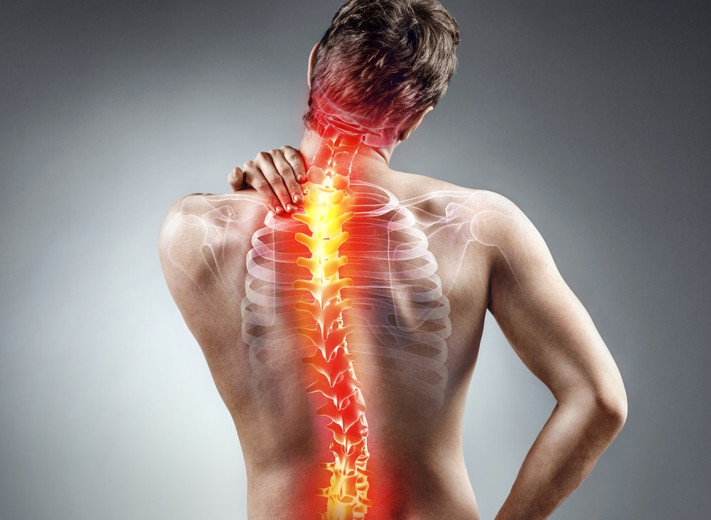 Young man holding his neck in pain. Medical concept