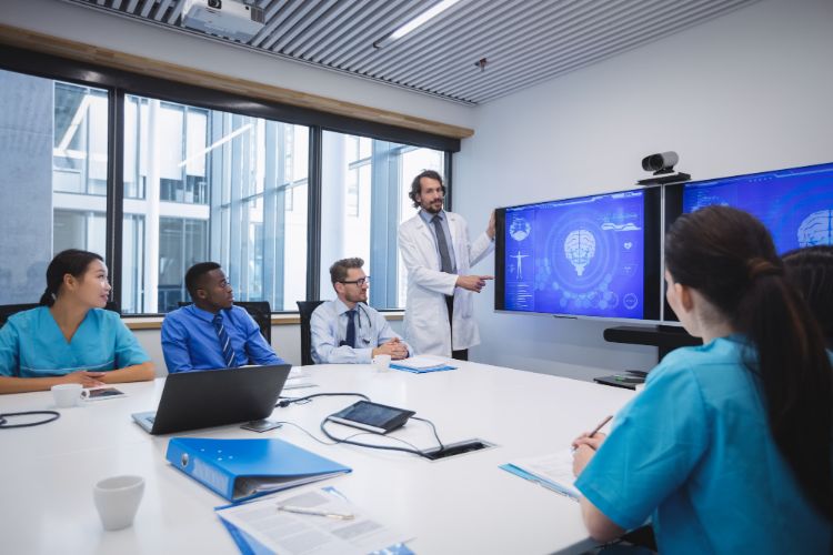 american medical association doctor giving presentation to team