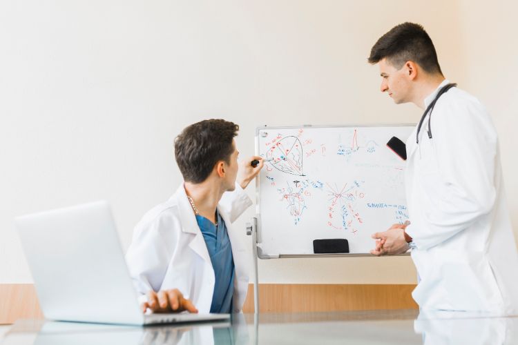 referral and a prior authorization health services doctors with a laptop and whiteboard