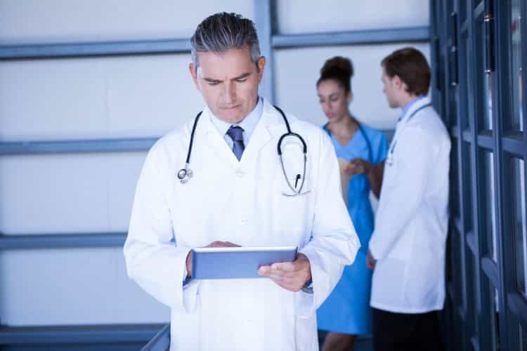 medical information doctor looking at digital tablet