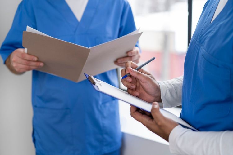 nurses with documents at hospital