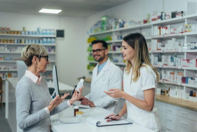 patient care of a pharmacists giving prescriptions to a patient