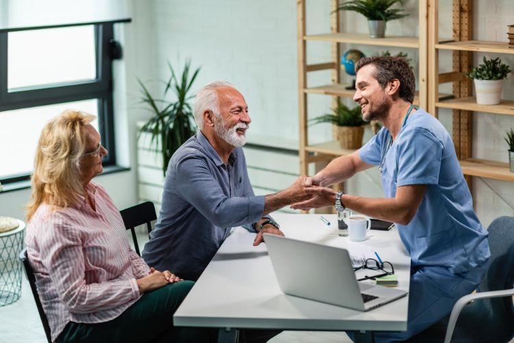 requested treatment doctor shaking hands with senior man