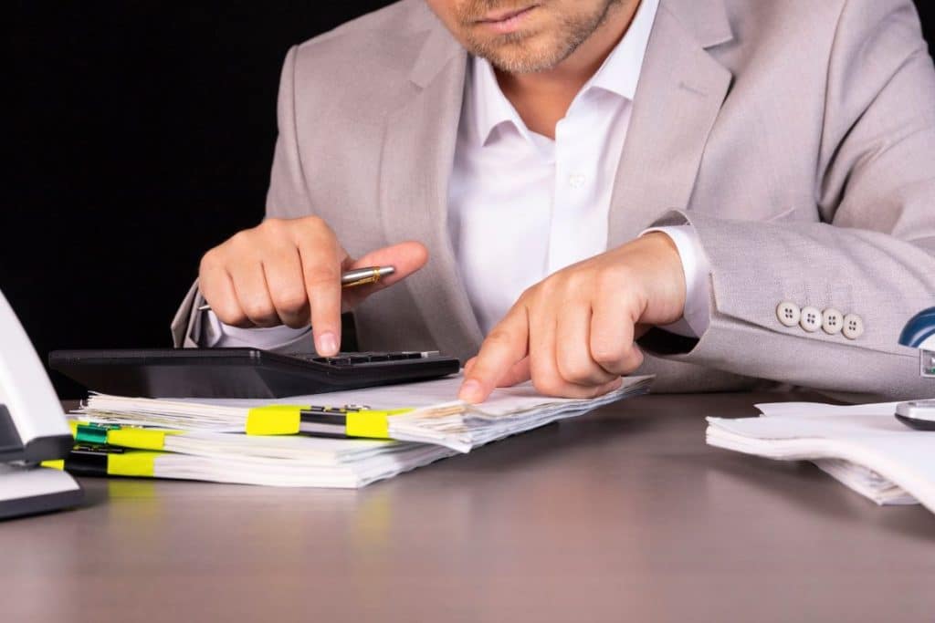 managing prior authorization man calculating