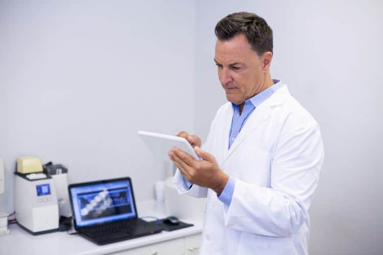 plan documents doctor using digital tablet