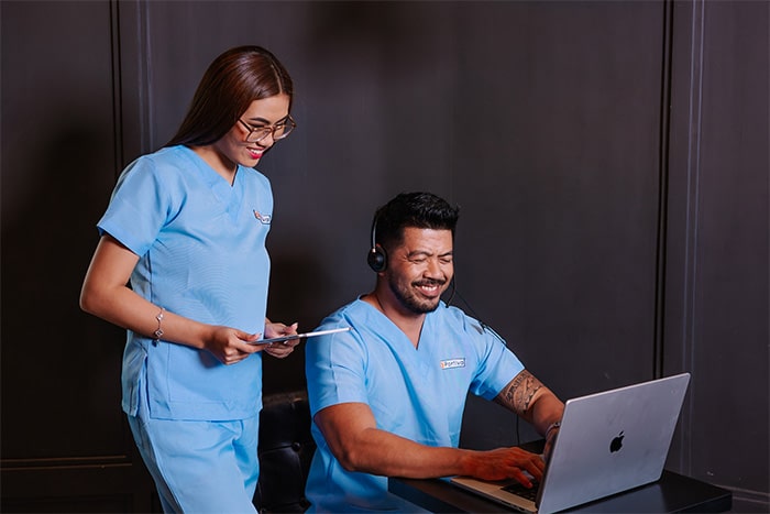 global best practices in prior authorization of Portiva, VA's woman and man looking at the laptop