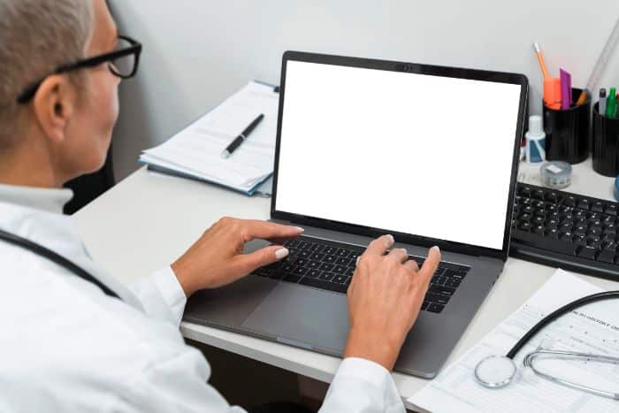 patient's complete guide to navigate prior authorization doctor working in laptop