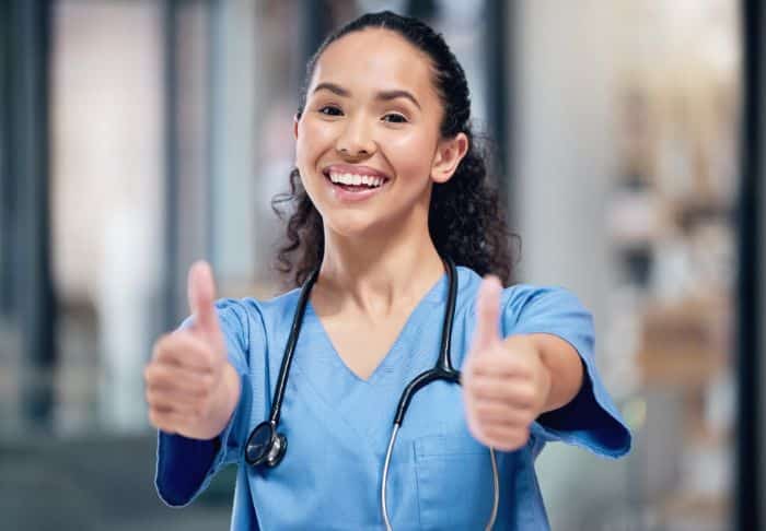 outsourcing the preauthorization process thumbs up female doctor