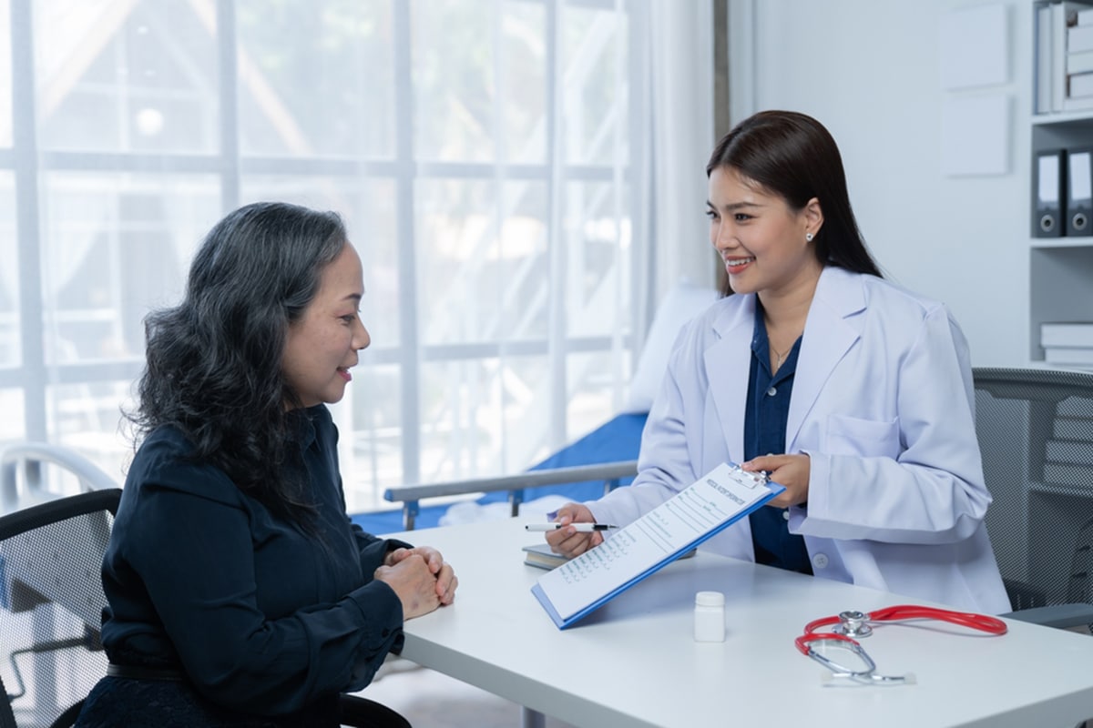 engaging patients in prior authorization doctor showing a clipboard to the patient