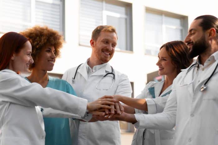 international approaches to prior authorization processes doctors holding hands