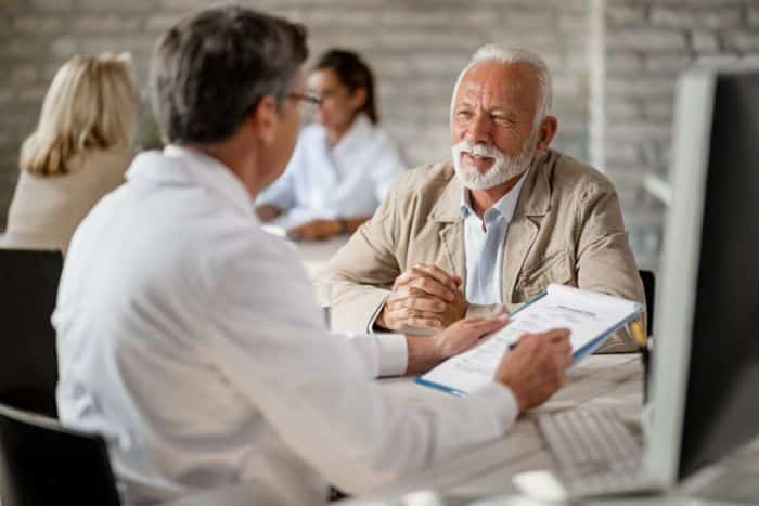 prior authorization and patient experience doctor talking with an old doctor