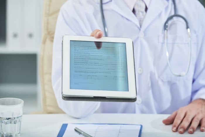 prior authorization unveiled doctor holding a tablet