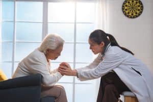 providers vs. payers in prior authorization emotional old patient holding a hand to a doctor