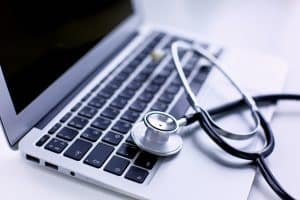 day in the life of a virtual medical receptionist, laptop with stethoscope