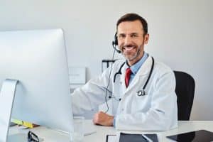 embracing virtual medical receptionists, doctor using computer