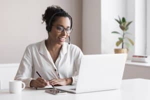 emergence of virtual medical receptionists VA writing something while using the laptop