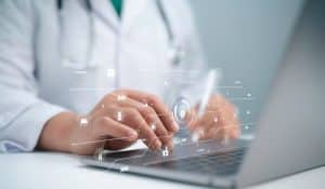 virtual medical receptionist benefits, unknown doctor using a laptop