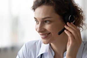 virtual medical receptionist benefits, woman wearing headphone