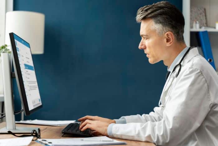 virtual medical receptionist male doctor looking at the monitor