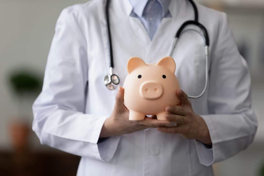 virtual medical receptionists a cost-effective, doctor holding a piggy bank
