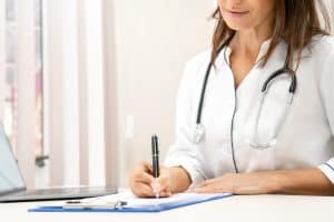 virtual medical receptionists solution, female doctor writing