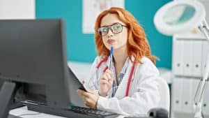 healthcare administration with virtual medical receptionists doctor using computer and overthinking