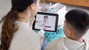 patient loyalty with virtual medical receptionists mother and child video calling the doctor