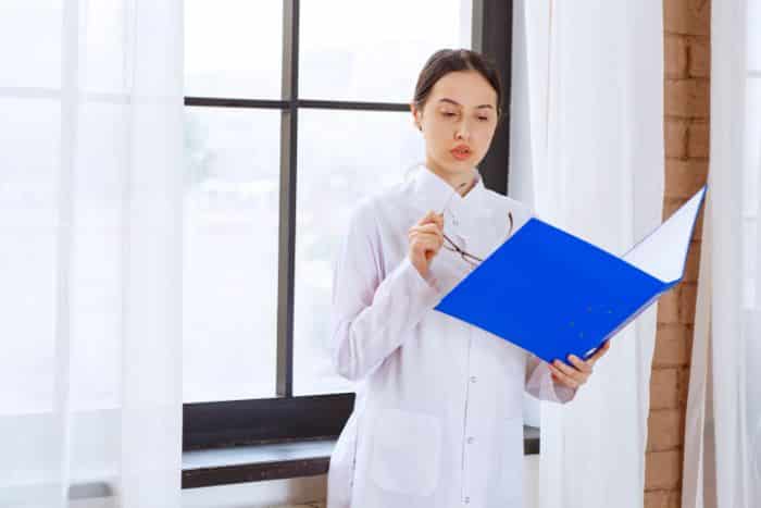 medical receptionist job responsibilities young doctor reading