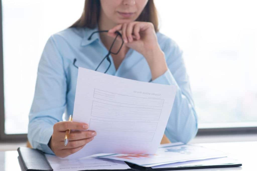 patient care coordinator job description woman reading the paper