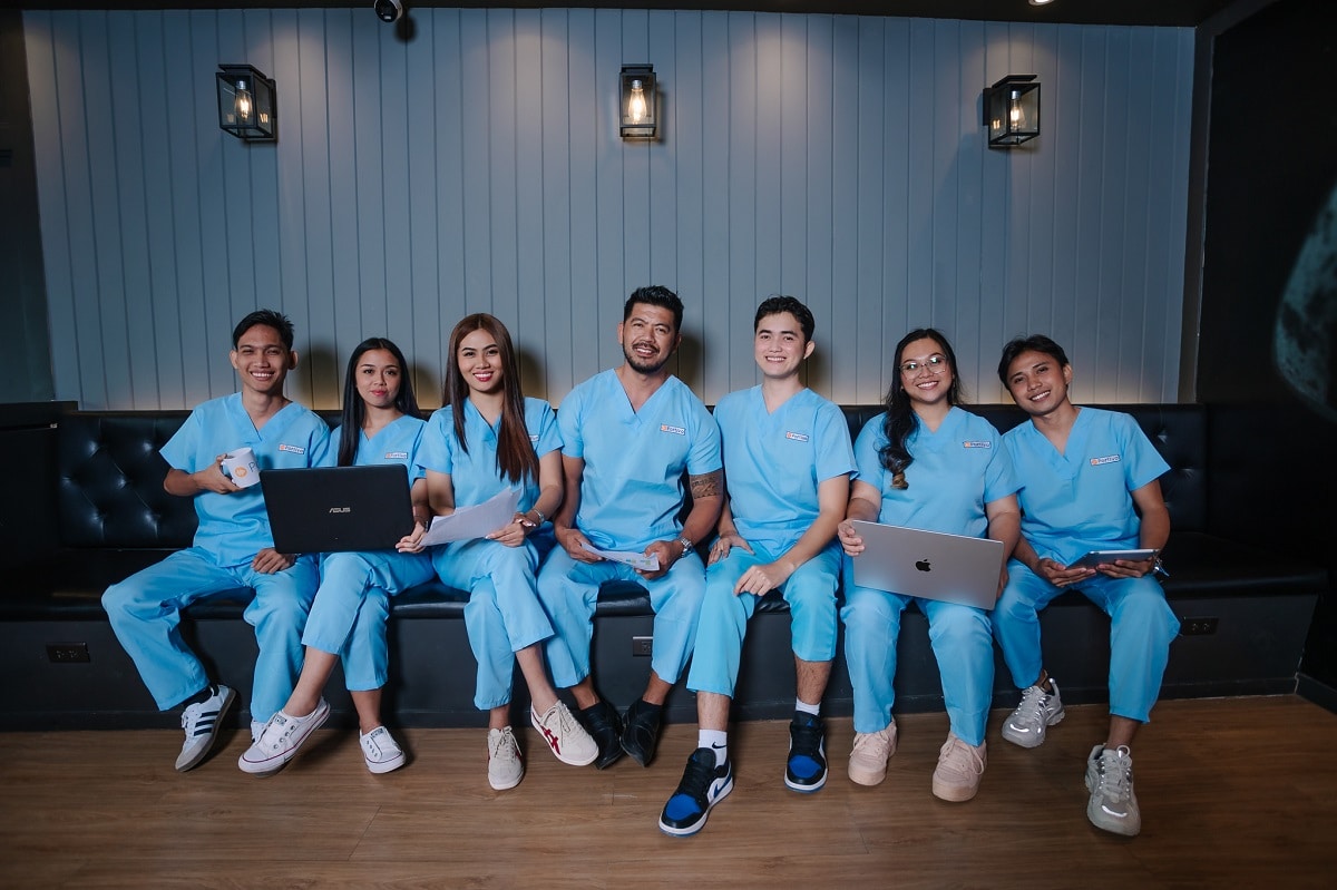 how to get a doctors note from a walk in clinic wiht Seven people wear light blue scrubs and sit on a black couch