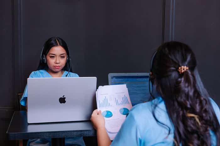 smiling young female holding laptop