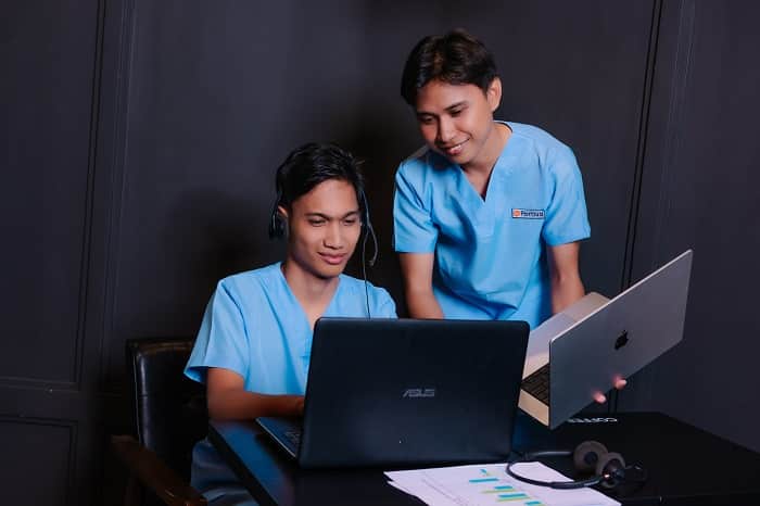 two male wearing blue scrub