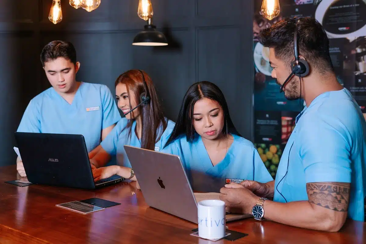 Front desk patient flow virtual medical assistant team coordinating patient scheduling, intake readiness, and healthcare communication workflows in a busy medical practice